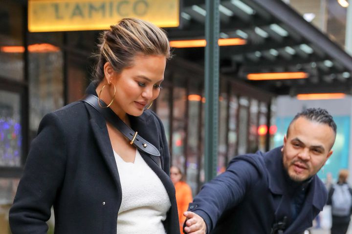 A doorman from a nearby building stopped Chrissy Teigen from stepping onto the street.
