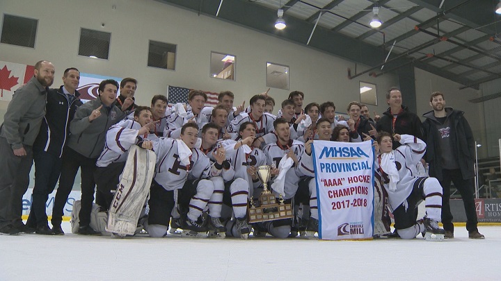 The St. Paul's Crusaders celebrate their third straight AAAA provincial high school hockey championship.