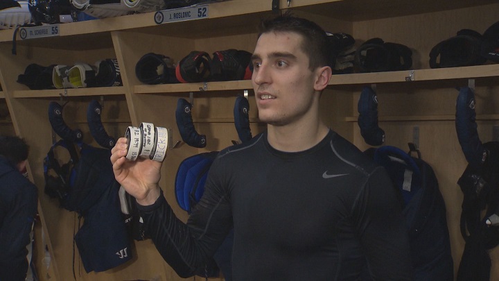 Winnipeg Jets forward Brandon Tanev holds his three goal pucks after his first career hat trick in Tuesday's win over the Boston Bruins.