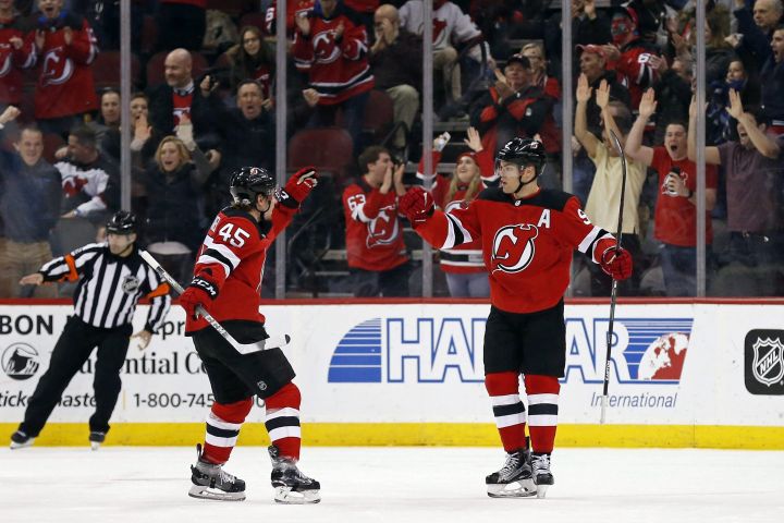 New Jersey Devils left wing Taylor Hall (9) is congratulated by Devils defenseman Sami Vatanen (45) after scoring a goal against the Minnesota Wild during the first period of an NHL hockey game, Thursday, Feb. 22, 2018, in Newark, N.J.