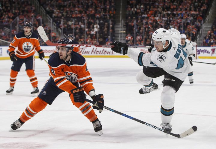 San Jose Sharks centre Tomas Hertl (48) gets the shot away as Edmonton Oilers defenceman Kris Russell (4) defends during first period NHL action in Edmonton, Alta., on Wednesday March 14, 2018. 