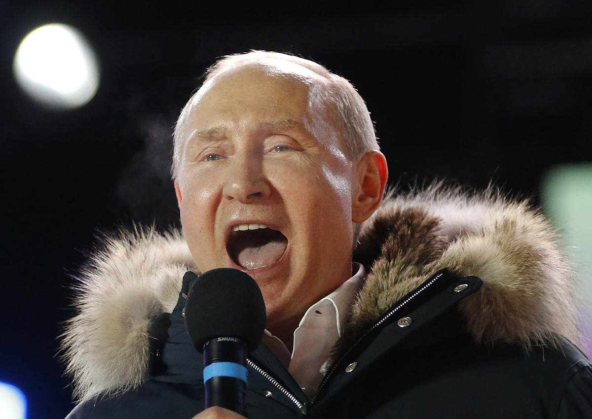 In this March 18, 2018 photo, Russian President Vladimir Putin speaks to supporters during a rally near the Kremlin in Moscow.