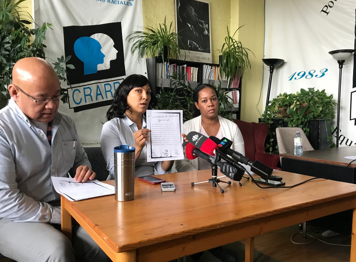 In this March 2018 file photo, CRARR's Fo Niemi (left) can be seen sitting next to mothers Asha (centre) and Nathalie (right). The Quebec Human Rights Commission has awared Asha and her two children $65,000. Monday, Dec. 7, 2020.