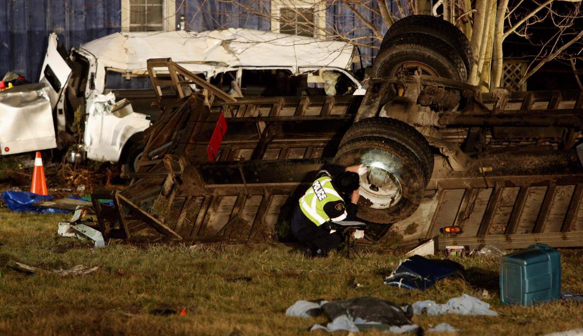 Ontario Provincial Police and emergency crews investigate a multiple fatal motor vehicle accident near Hampstead, Ontario, Monday, February 6, 2012.