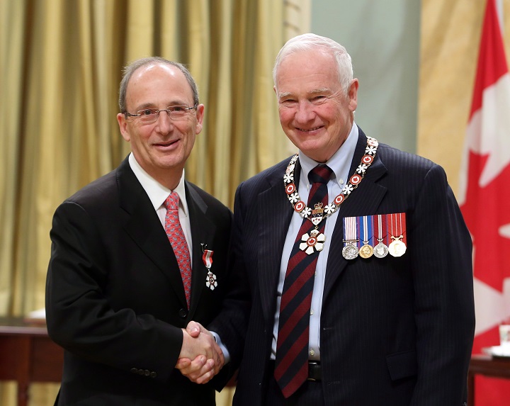 In this 2014 file photo, lawyer and newspaper publisher, Michael Goldbloom of Montreal (left) shakes hands with former governor general David Johnston as he was invested as Member to the Order of Canada at a ceremony at Rideau Hall. Goldbloom was appointed chair of the board of directors for CBC/Radio-Canada. Tuesday, April 3, 2018.