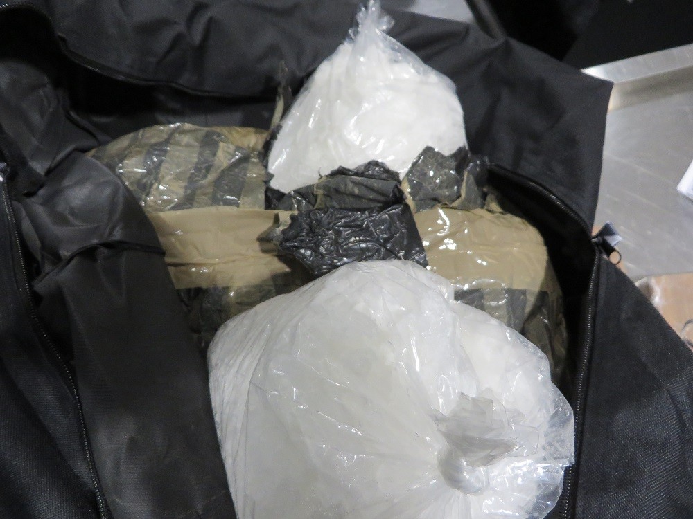 Canadian border officers say black nylon gym bags found inside luggage at Toronto's Pearson airport contained packages of methamphetamine and heroin.