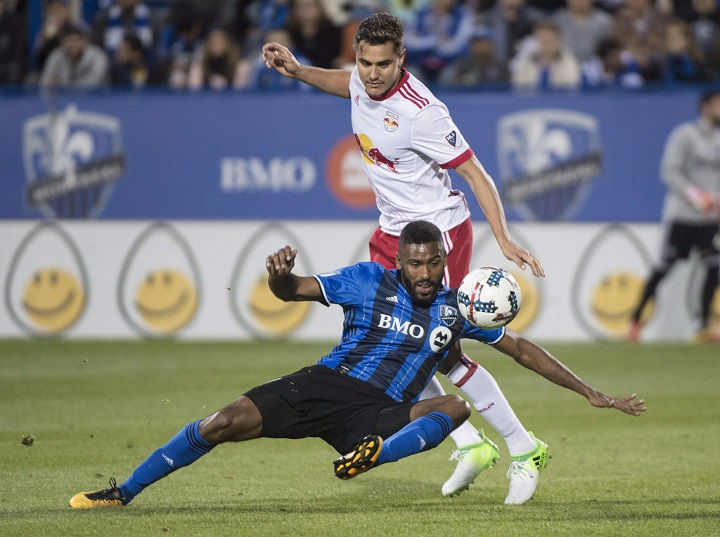 In this file photo, Montreal Impact forward Anthony Jackson-Hamel falls in front of New York Red Bulls midfielder Aaron Long during second half MLS action Saturday, June 3, 2017 in Montreal. 
