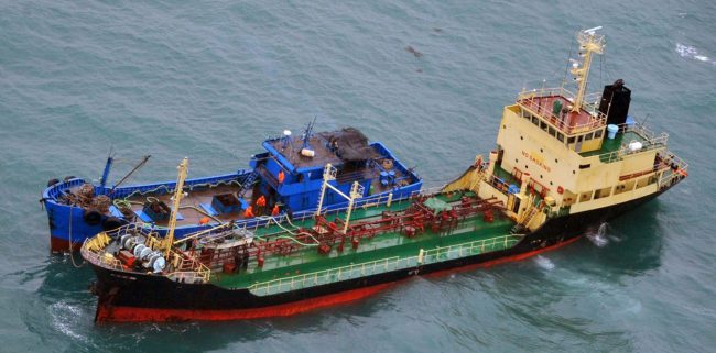 This Feb. 16, 2018 photo released by Japan's Ministry of Foreign Affairs shows what Japan says is a North Korean-flagged tanker lying alongside a small vessel of unknown nationality in the East China Sea, some 250 km east of Shanghai.