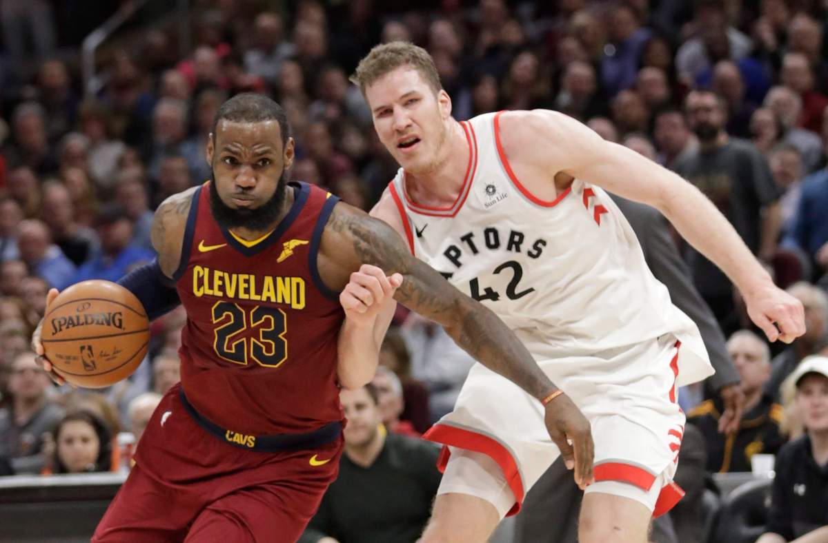 Cleveland Cavaliers' LeBron James (23) drives past Toronto Raptors' Jakob Poeltl (42) during the second half of an NBA basketball game Wednesday, March 21, 2018, in Cleveland. The Cavaliers won 132-129. (AP Photo/Tony Dejak).