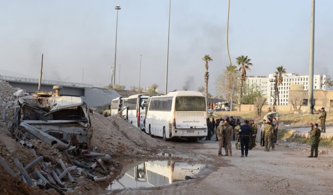 Syrian government buses carrying people drive out from Erbin town, Eastern Ghouta, Damascus countryside, Syria, 25 March 2018.