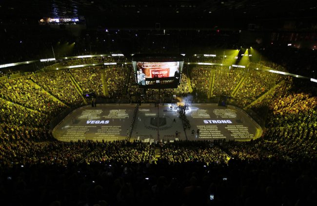 The names of people killed during the mass shooting in Las Vegas last year are projected on the ice during a ceremony before an NHL hockey game between the Vegas Golden Knights and the San Jose Sharks, March 31, 2018, in Las Vegas.