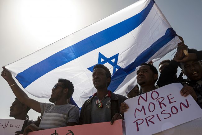In this Feb. 22, 2018 file photo, asylum seekers march during a protest outside Israeli Prison Saharonim, in the Negev desert, southern Israel. 


