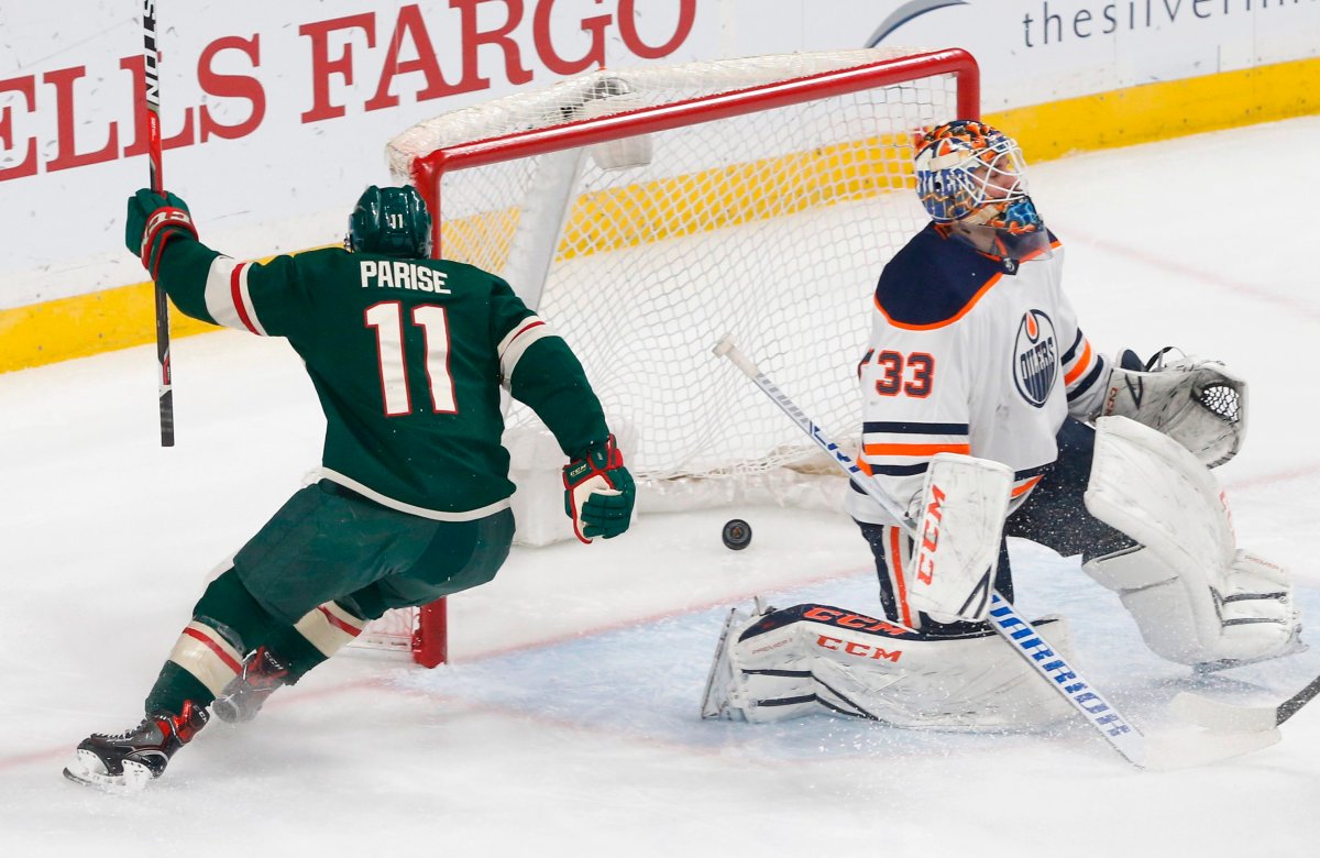 Minnesota Wild's Zach Parise, left, scores on Edmonton Oilers' goaltender Cam Talbot in the first period of an NHL hockey game Monday, April 2, 2018, in St. Paul, Minn. (AP Photo/Jim Mone).
