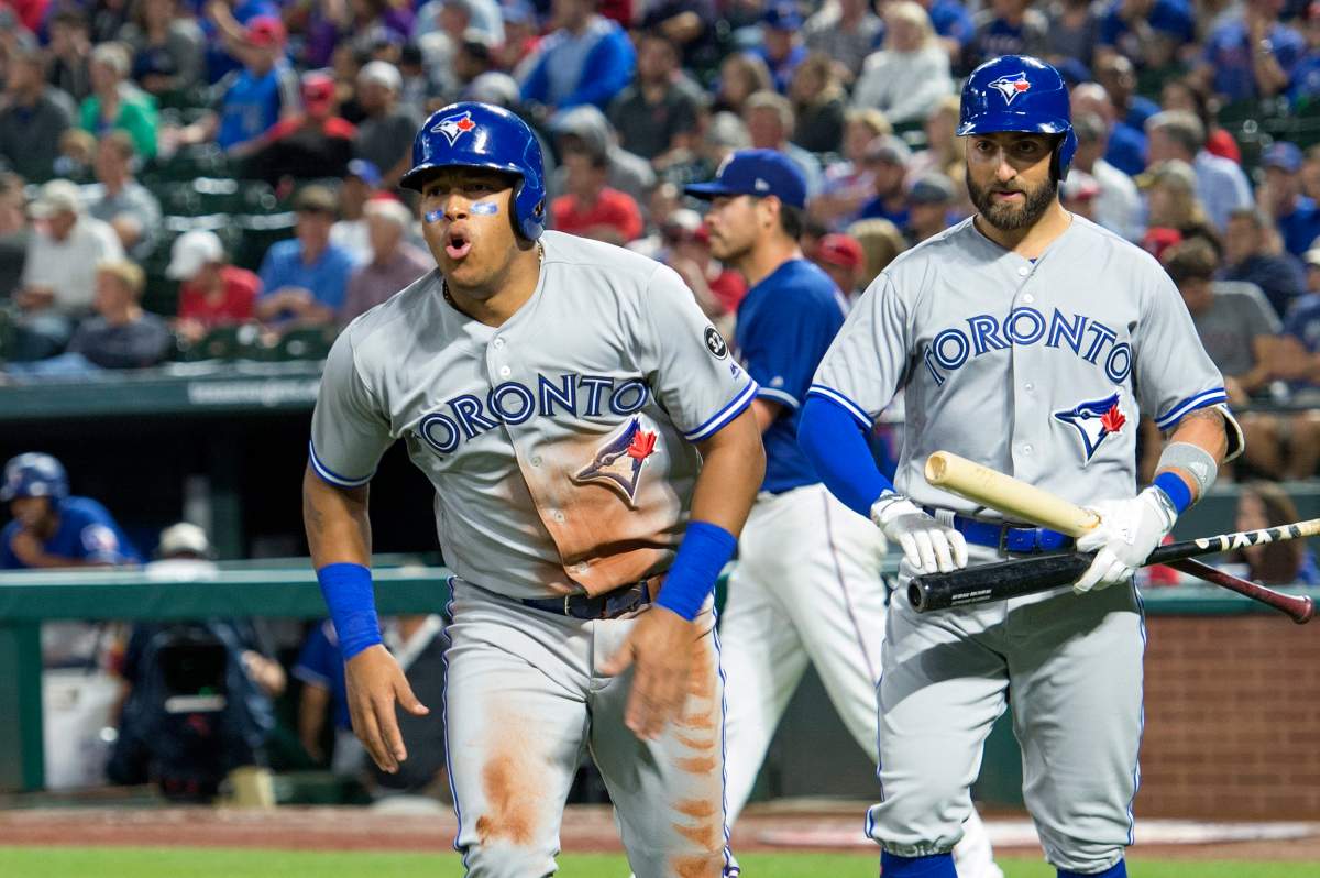 Toronto Blue Jays' Yangervis Solarte celebrates after scoring on a sacrifice fly by Kendrys Morales during the third inning of a baseball game against the Texas Rangers on Friday, April 6, 2018, in Arlington, Texas.