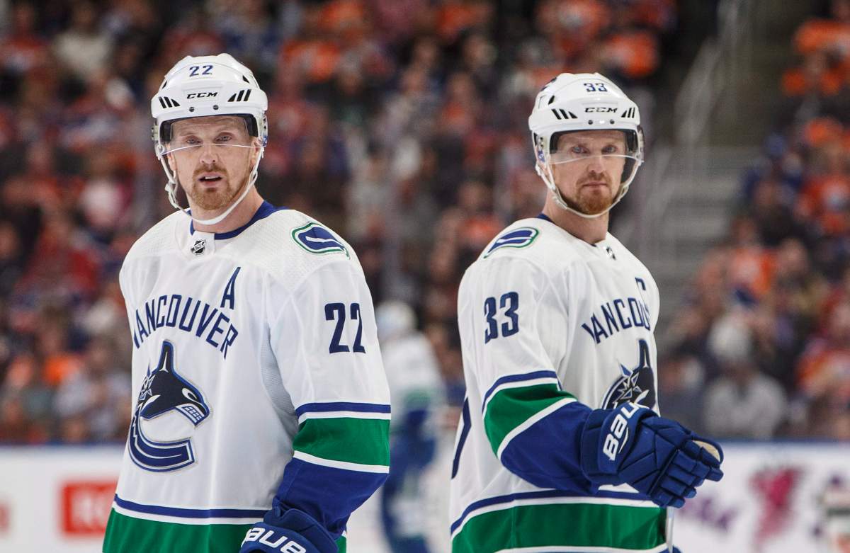 Vancouver Canucks' Daniel Sedin (22) and Henrik Sedin (33) skate past each other against the Edmonton Oilers during first period NHL action in Edmonton, Alta., on Saturday April 7, 2018. THE CANADIAN PRESS/Jason Franson.