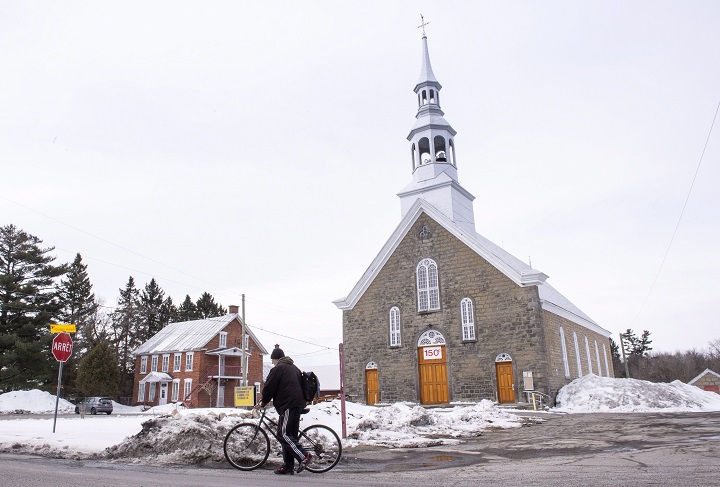 The church in Sainte-Sophie, Que. is seen on Friday, April 6, 2018. For more than 150 years, the church in Sainte-Sophie, Que. has stood in the heart of the village, its steeple like a beacon summoning the faithful through its doors. But with so few answering the call each Sunday, the small town northwest of Montreal is one of many facing what once would have been unimaginable: a churchless future. 