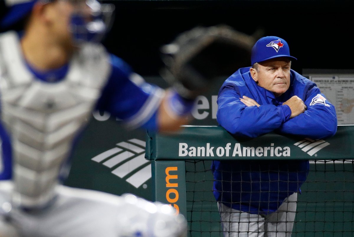 Toronto Blue Jays manager John Gibbons is seen past Blue Jays catcher Luke Maile as he watches the fourth inning of a baseball game against the Baltimore Orioles, Wednesday, April 11, 2018, in Baltimore.