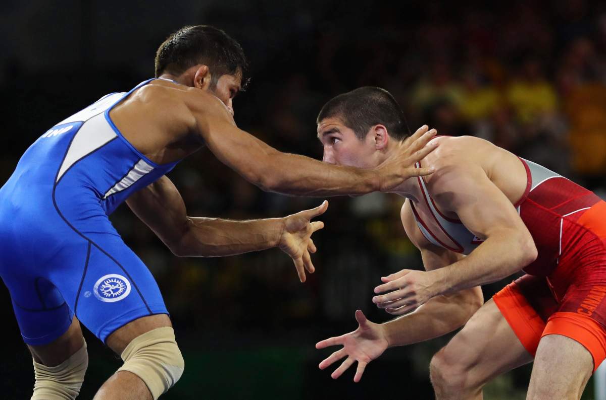 India’s Rahul Aware, in blue, wrestles with Canada’s Steven Takahashi to win Gold medal in men’s FS 57Kg wrestling at the Commonwealth Games on Gold Coast, Australia, Thursday, April 12, 2018. (AP Photo/Manish Swarup)
