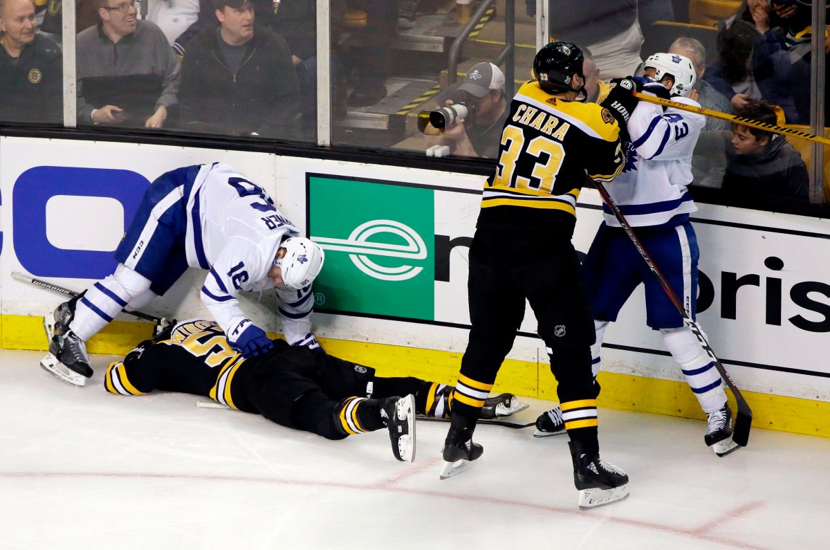 In this April 12, 2018, file photo, Boston Bruins defenseman Zdeno Chara (33) shoves Toronto Maple Leafs center Nazem Kadri (43) to retaliate for his late hit on Boston Bruins center Tommy Wingels (57), bottom left, as Maple Leafs center Mitchell Marner (16) starts to get up during the third period of Game 1 of an NHL hockey first-round playoff series, in Boston. 