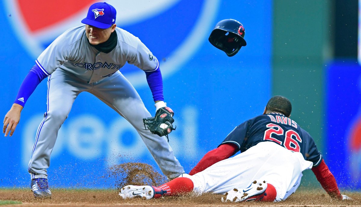 Toronto Blue Jays' Aledmys Diaz is late on a tag as Cleveland Indians' Rajai Davis steals second during the second inning of a baseball game Friday, April 13, 2018, in Cleveland.