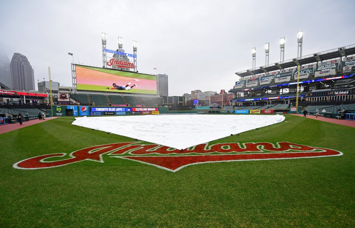 A tarp covers the field during a rain delay of a baseball game between the Toronto Blue Jays and Cleveland Indians, Saturday, April 14, 2018, in Cleveland. 
