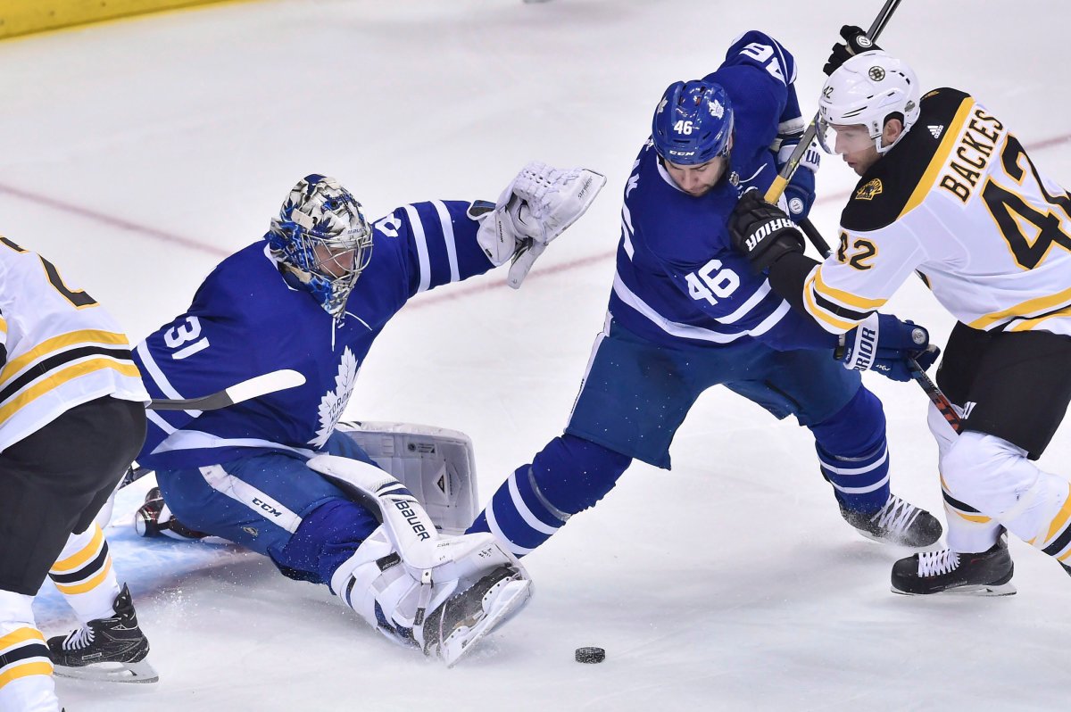 Toronto Maple Leafs defenceman Roman Polak (46) battles Boston Bruins right wing David Backes (42) in front of Leafs goaltender Frederik Andersen (31) during second period NHL round one playoff hockey action in Toronto on Monday, April 15, 2018. 
