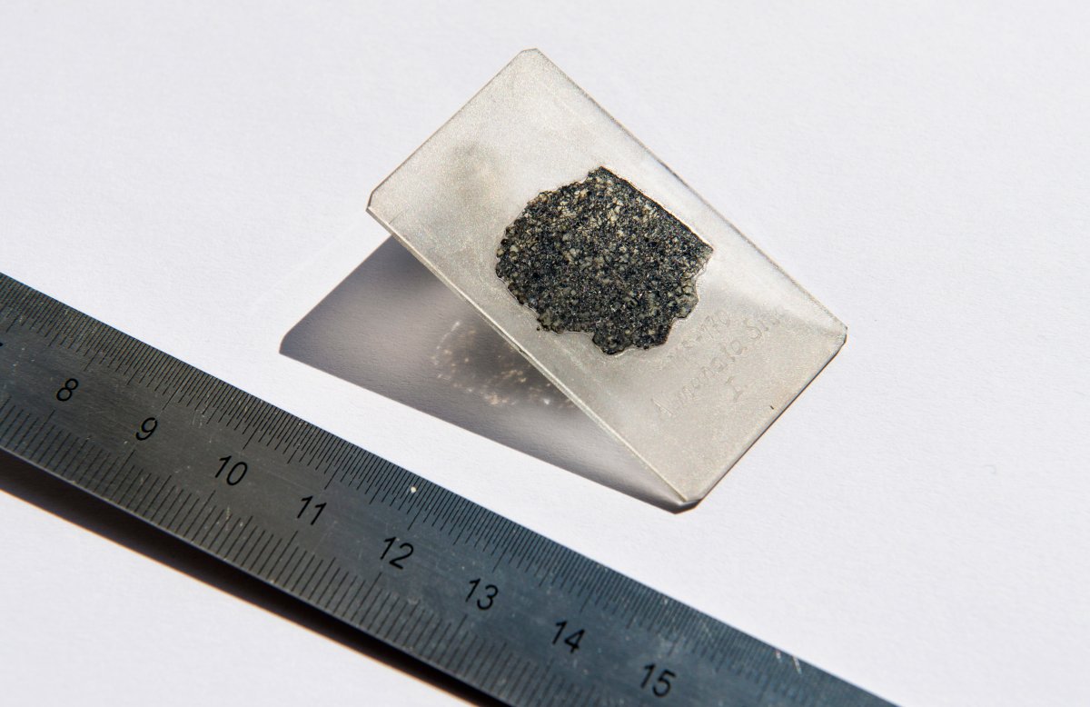 Photo provided by Hillary Sanctuary of EPFL shows a thin slice of the meteorite sample from a meteorite that fell to Earth more than a decade ago providing compelling evidence of a lost planet that once roamed our solar system, according to a study published Tuesday. 