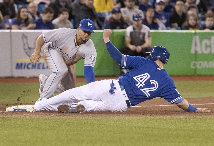 Kansas City Royals third baseman Cheslor Cuthbert puts the tag on Toronto Blue Jays' Justin Smoak for the out at third base in the sixth inning in the first game of their American League MLB baseball doubleheader in Toronto on Tuesday April 17, 2018.