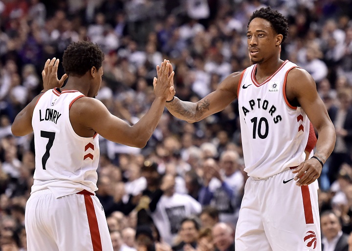 Toronto Raptors guard Kyle Lowry (7) and teammate DeMar DeRozan (10) celebrate a basket during first half NBA basketball action against the Washington Wizards, in Toronto on Tuesday.