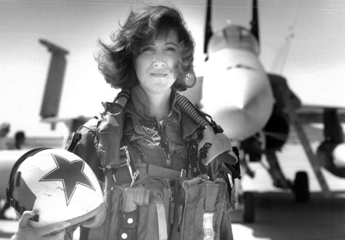 In this image provided by the U.S. Navy, Lt. Tammie Jo Shults, one of the first women to fly Navy tactical aircraft, poses in front of an F/A-18A with Tactical Electronics Warfare Squadron (VAQ) 34 in 1992. After leaving active duty in early 1993, Shults served in the Navy Reserve until 2001. Shults was the pilot of the Southwest plane that made an emergency landing on April 17, 2018, after an engine explosion. (Thomas P. Milne/U.S. Navy via AP)