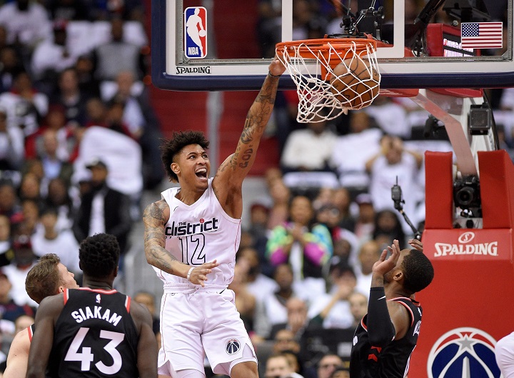 Washington Wizards forward Kelly Oubre Jr. (12) dunks against Toronto Raptors forward Pascal Siakam (43) and forward CJ Miles, right, during the first half of Game 3 of an NBA basketball first-round playoff series, Friday, April 20, 2018, in Washington. 