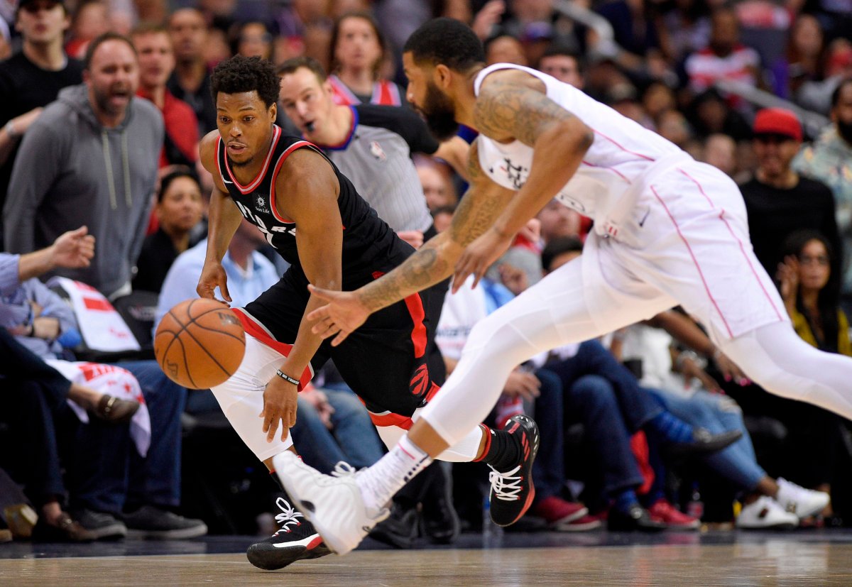 Toronto Raptors guard Kyle Lowry, left, chases the ball against Washington Wizards forward Markieff Morris, right, during the second half of Game 4 of an NBA basketball first-round playoff series, Sunday, April 22, 2018, in Washington. (AP Photo/Nick Wass).