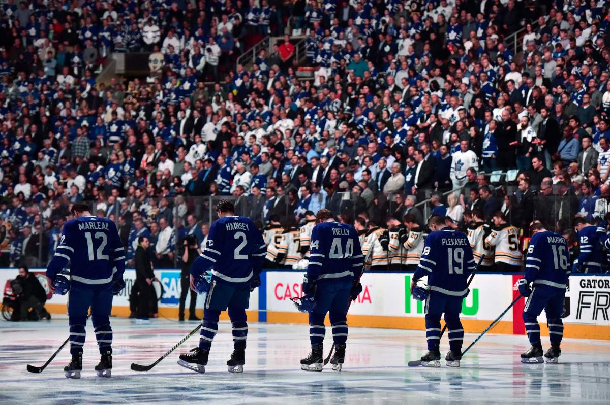 Players and fans stand for a moment of silence before first period NHL round one playoff hockey action against the Boston Bruins in Toronto on Monday, April 23. THE CANADIAN PRESS/Frank Gunn