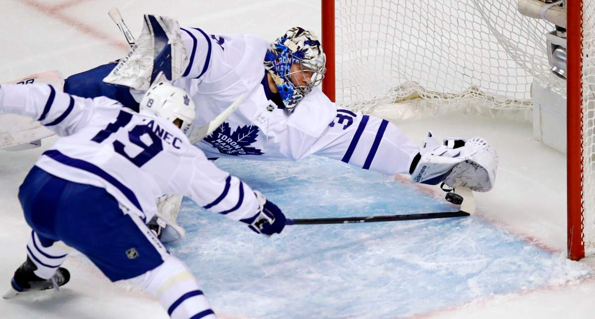 Toronto Maple Leafs goaltender Frederik Andersen and center Tomas Plekanec (19) stretch to make a save against the Boston Bruins during the first period of Game 7 of an NHL hockey first-round playoff series in Boston, Wednesday, April 25, 2018.