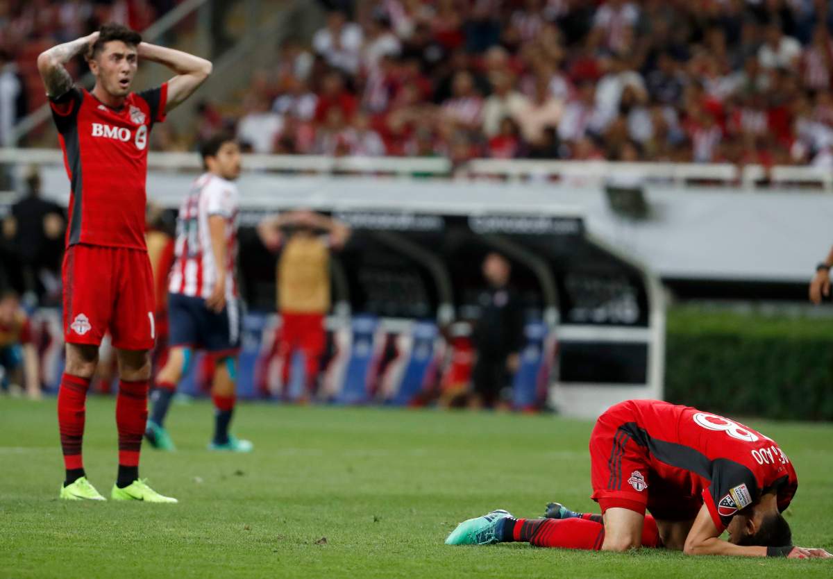Toronto FC Ager Aketxe, right, pounds the pitch in disbelief after missing a shot to score against Chivas during the championship of the CONCACAF Champions League final soccer match in Guadalajara, Mexico, Wednesday, April, 25, 2018. (AP Photo/Eduardo Verdugo).