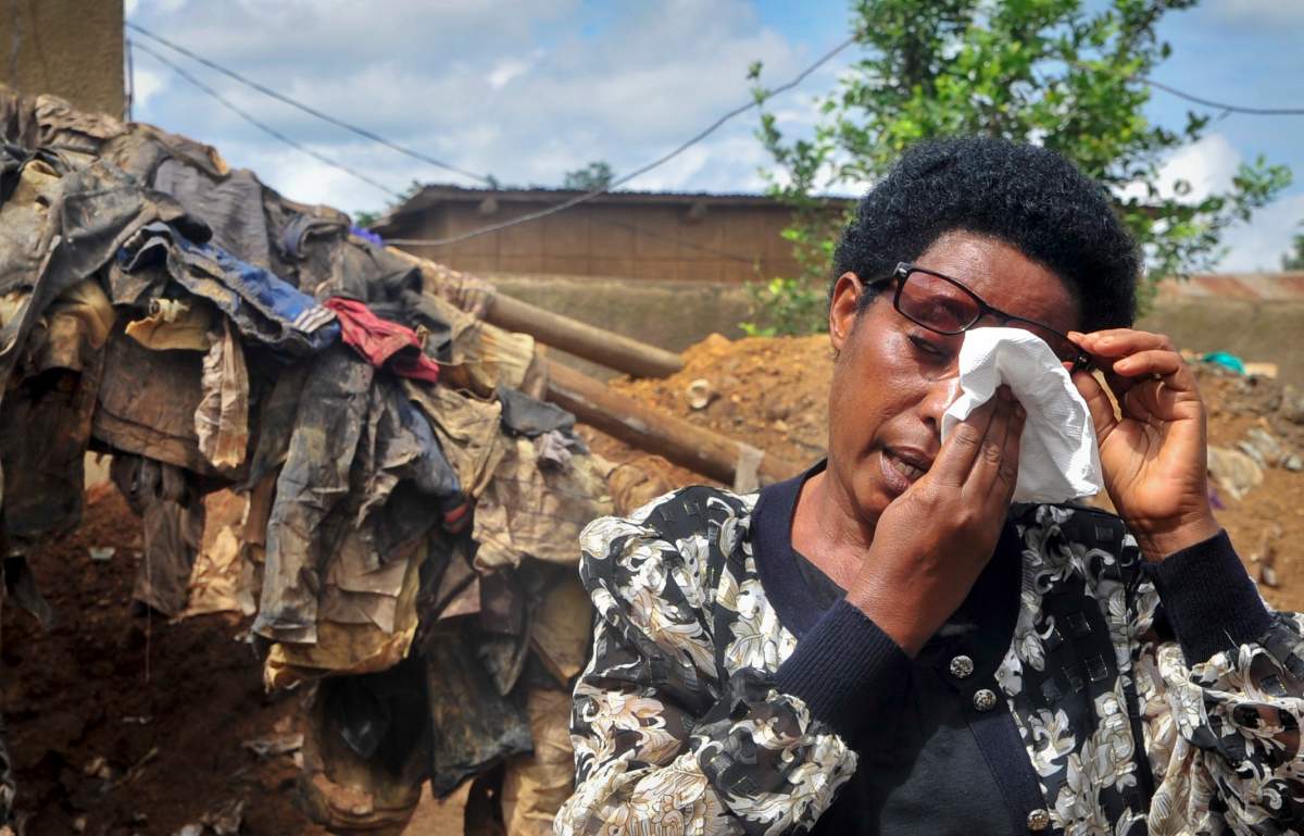 France Mukantagazwa, who lost her father and other relatives in the genocide and believes their bodies may be in the newly found graves, sheds a tear as she speaks to media at the site of the recently-discovered mass grave in Gasabo district, near the capital Kigali, in Rwanda Thursday, April 26, 2018. 