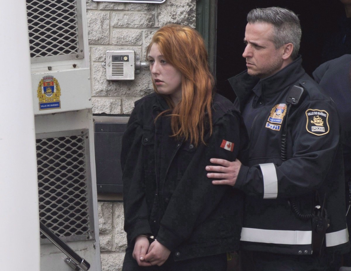 Audrey Gagnon is escorted by police on her way to the courthouse in Quebec City, Thursday, April 19, 2018. 