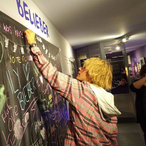 Justin Bieber signs a message board at the Stratford Perth Museum on Friday, April 27, 2018 in this handout photo.