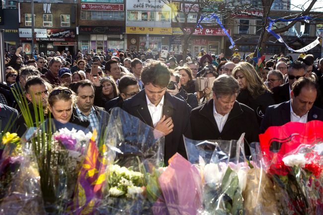Justin Trudeau visits a memorial wall with Gov.-Gen. Julie Payette (left) and Mayor John Tory (right) before attending a vigil for the victims of the Toronto van attack on Sunday, April 29, 2018.