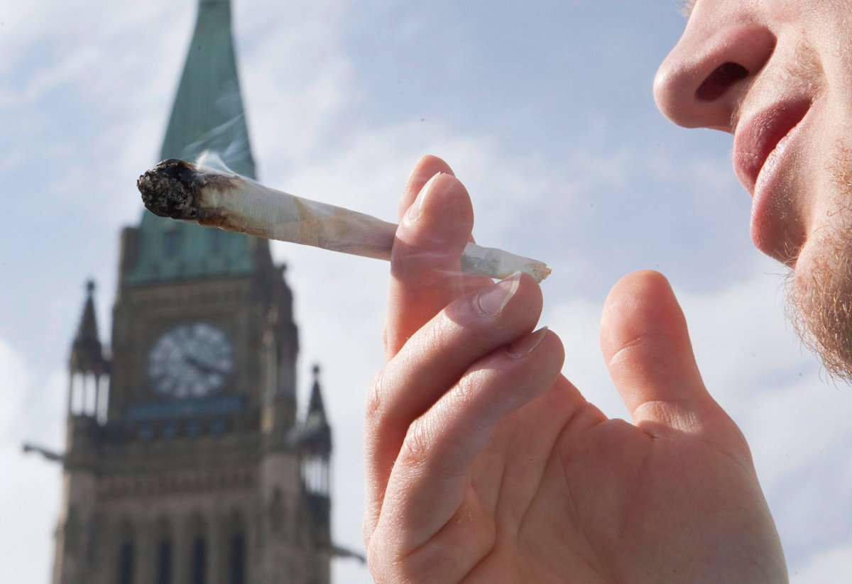 A demonstrator smokes a marijuana joint on Parliament Hill in Ottawa on Tuesday, April 20, 2010. Thousands of people gather annually on 4-20 (April 20th) on Parliament Hill to call for the decriminalization of marijuana. 