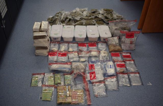 Cash and about two kilograms of drugs, including fentanyl, methamphetamine, cocaine, and MDMA, along with six kilograms of chemical precursors seized during the raid.