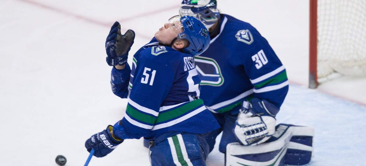 Vancouver Canucks' Troy Stecher (51) reacts after getting struck in the face by the puck during third period NHL hockey action against the Edmonton Oilers, in Vancouver, B.C., on Saturday, April 8, 2017. THE CANADIAN PRESS/Darryl Dyck.