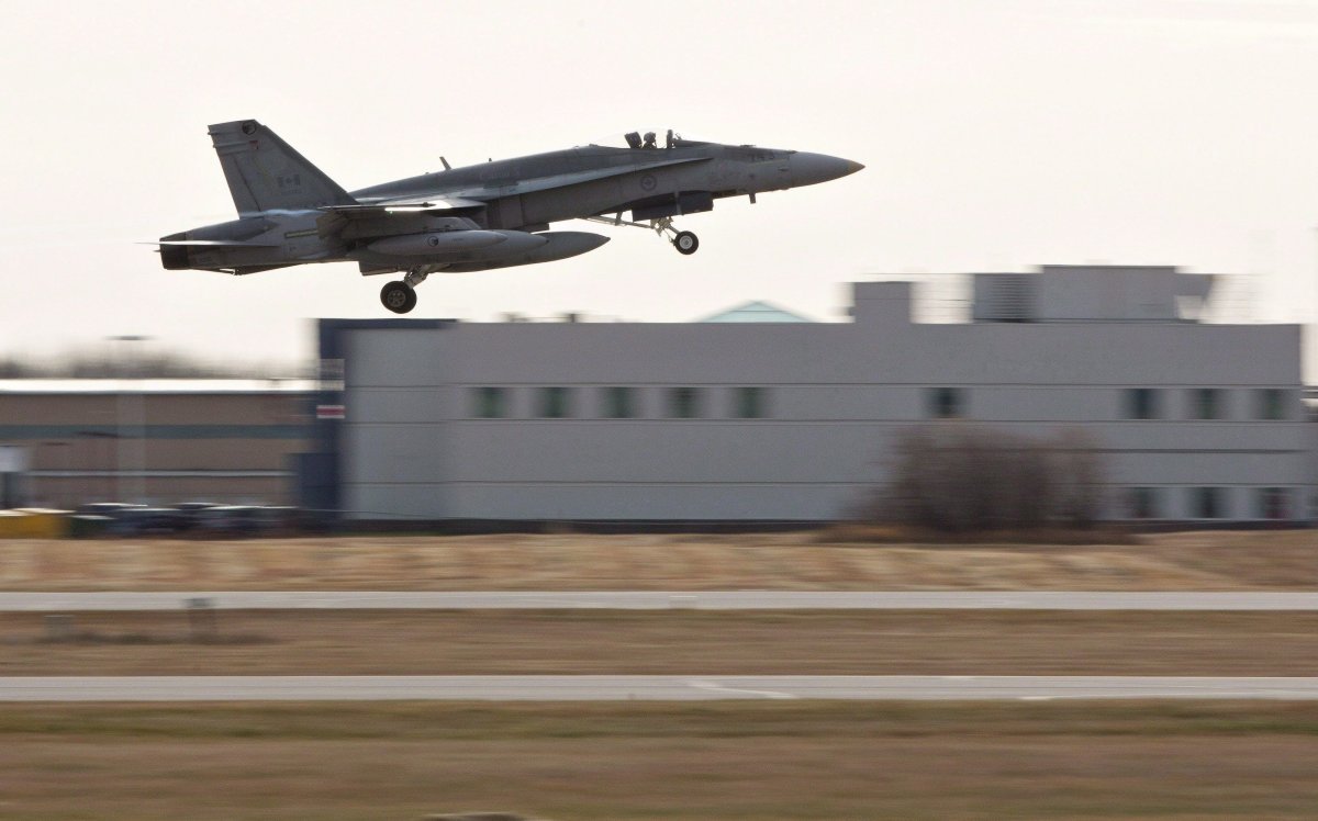A pilot takes off during the departure of CF-18 Hornets in support of Operation IMPACT, in Cold Lake, Alberta on Tuesday October 21, 2014.