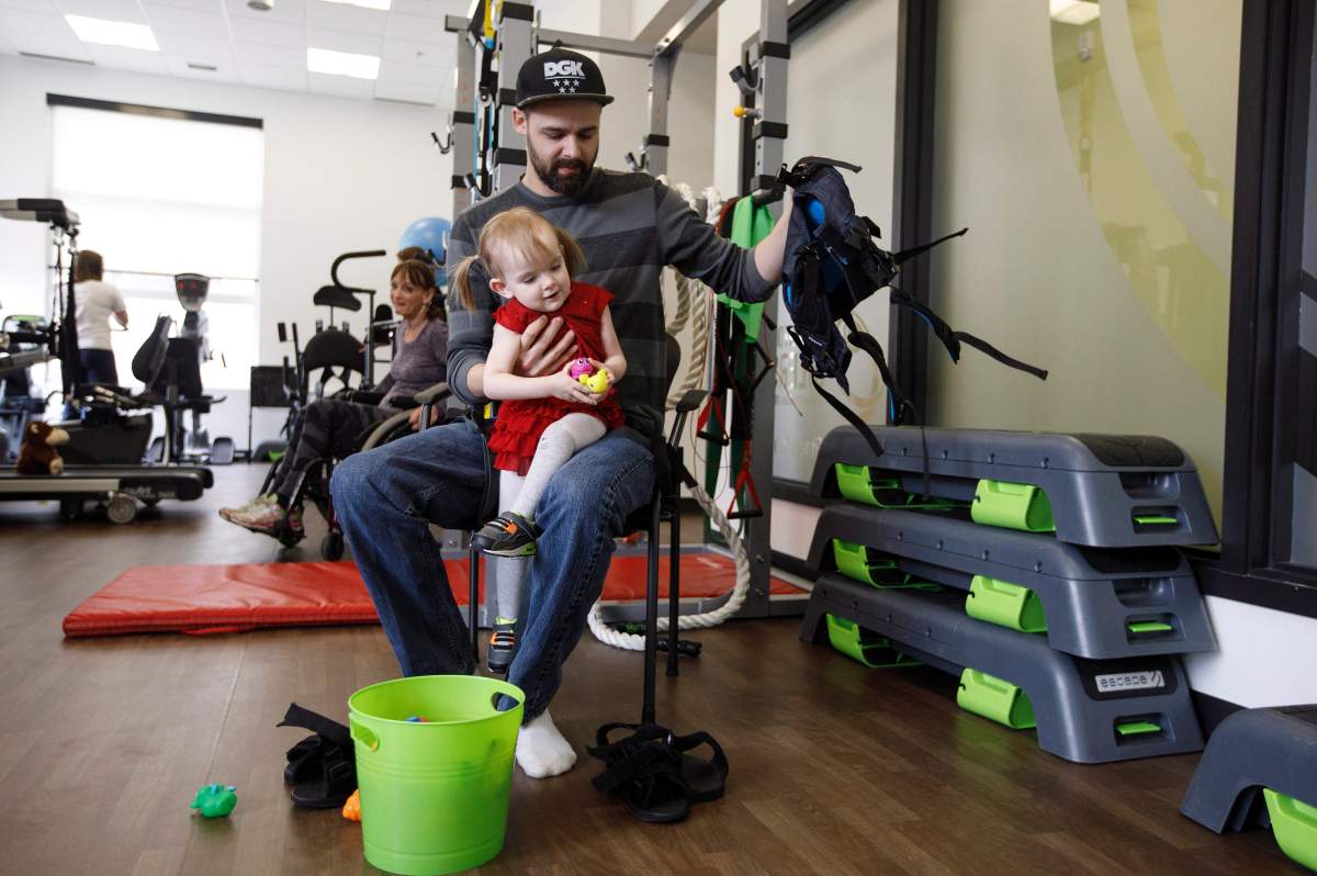 Evelyn Moore and her dad Brad Moore get ready for a walking exercise at the ReYu Paralysis Recovery Centre in Edmonton Alta, on Wednesday April 4, 2018.