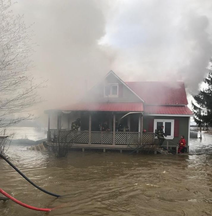 The Oromocto Fire Department was forced to extinguish a blaze Sunday morning while waist deep in flood water.  