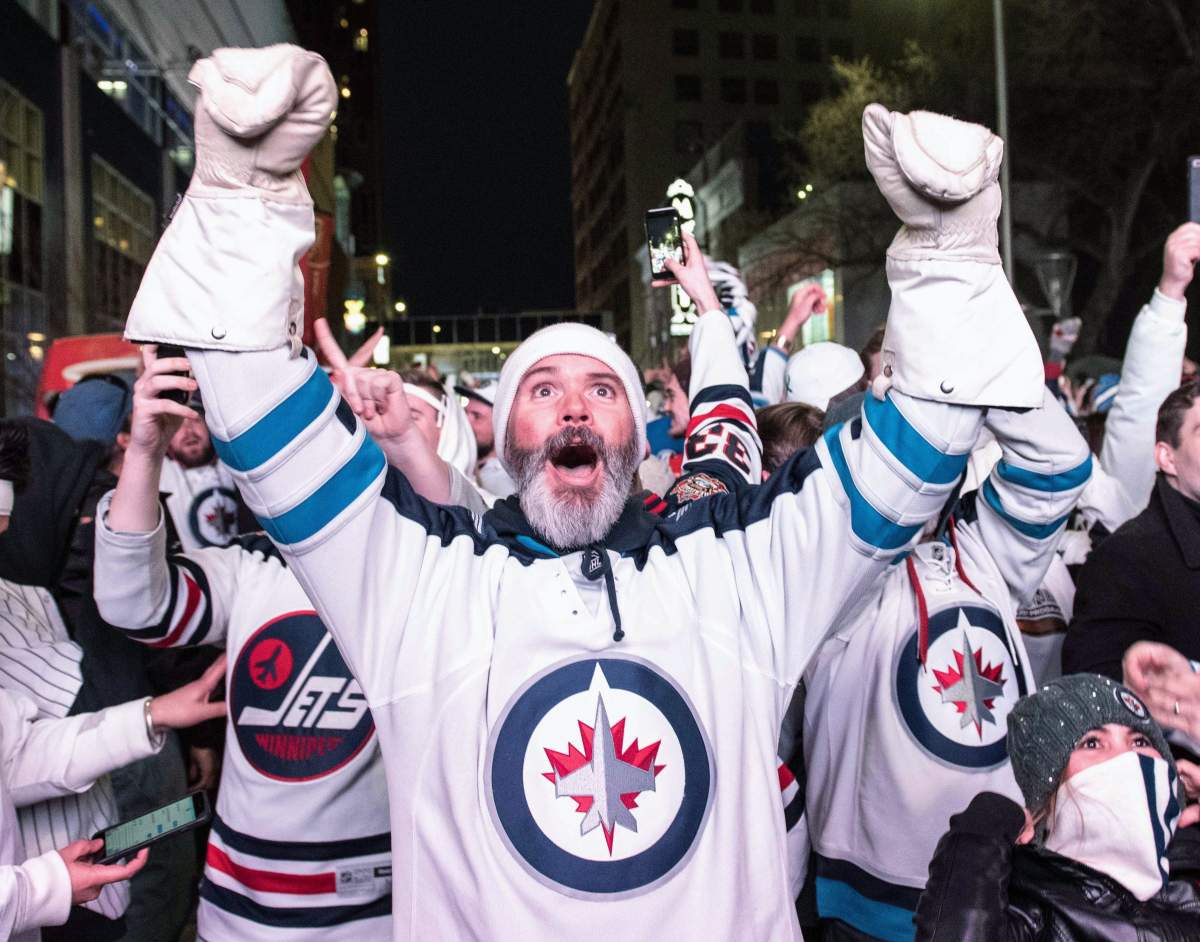 Winnipeg Jets fans celebrate a win over the Minnesota Wild in game one of NHL playoff action in Winnipeg on Wednesday, April 11, 2018. THE CANADIAN PRESS/ Mike Sudoma.