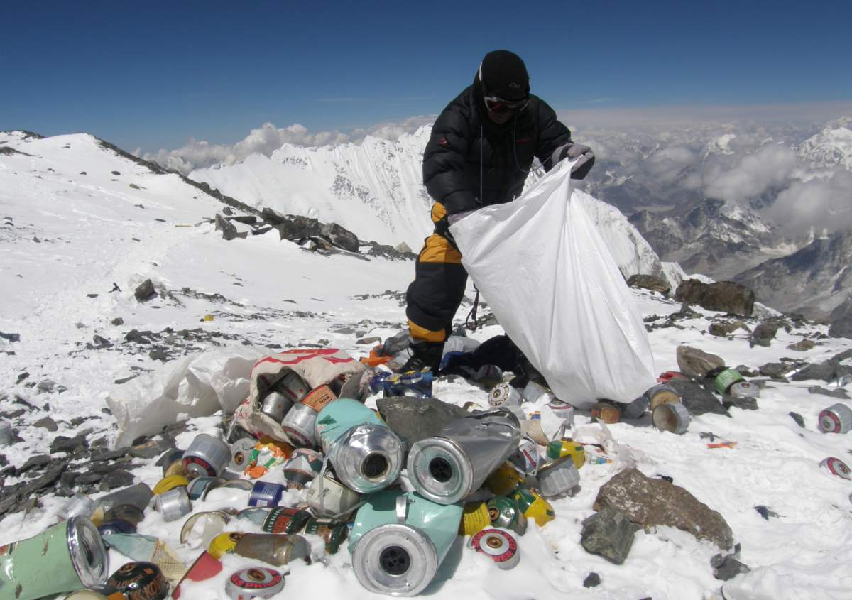 A Nepalese sherpa collecting garbage, left by climbers, at an altitude of 8,000 metres during the Everest clean-up expedition at Mount Everest.