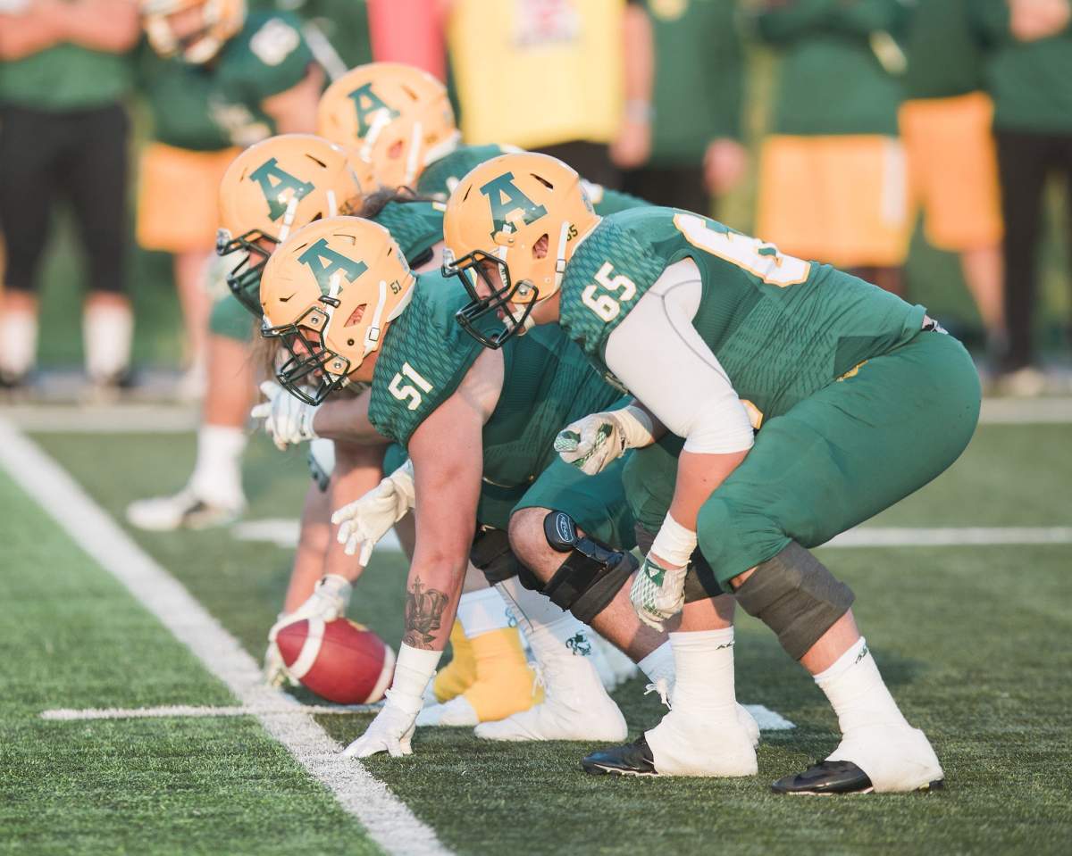 Alberta Golden Bears offensive lineman Mark Korte (65) lines up during U Sports football action against Calgary Dinos in this September 1, 2017. 