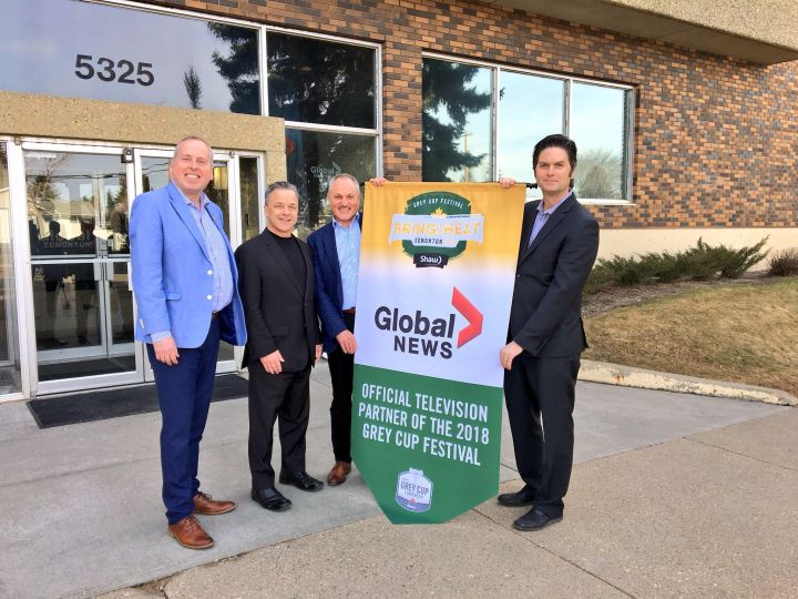 Eskimos president and CEO Len Rhodes (left), Global Edmonton station manager and news director Jim Haskins (second from left), 2018 Grey Cup co-chair Brad Sparrow (second from right) and Duane Vienneau, executive director of the 2018 Grey Cup (right), pose for a photo outside the Global Edmonton building on April 24, 2018.