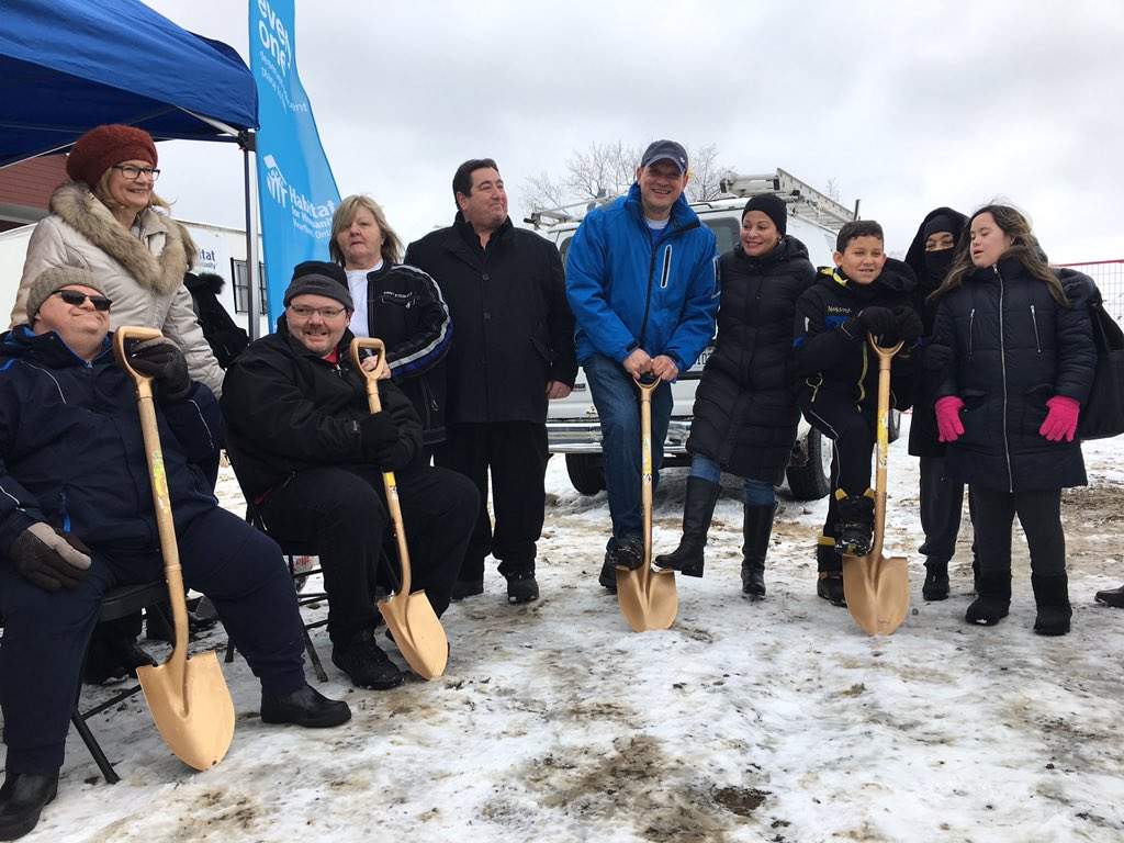 Future homeowners use golden shovel to break ground on the work site. 